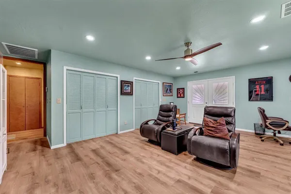 a bedroom with furniture and wooden floor