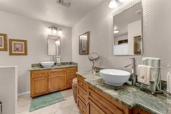 a spacious bathroom with a granite countertop toilet sink and mirror