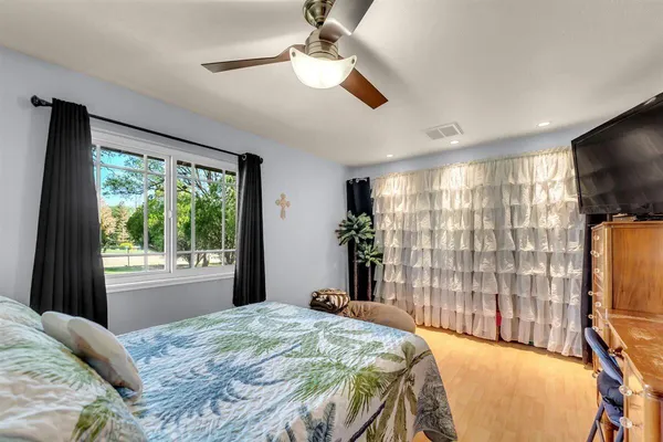 a bedroom with a bed and a flat tv screen