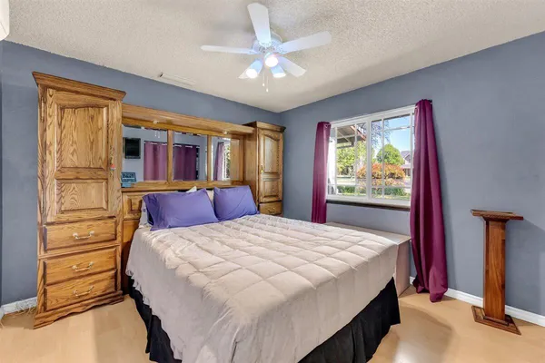 a bed sitting in a bedroom next to a window