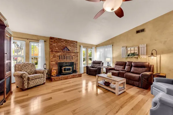 a living room with furniture fireplace and flat screen tv