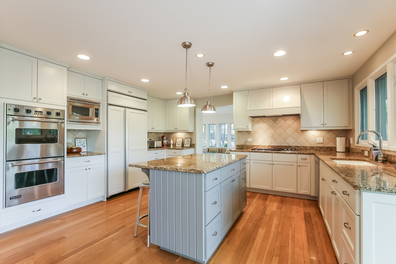 506 Forest Cove Road Lake Bluff, IL 60044 - Photo 13 of 53 a kitchen with stainless steel appliances granite countertop a stove a sink a refrigerator and white cabinets with wooden floor