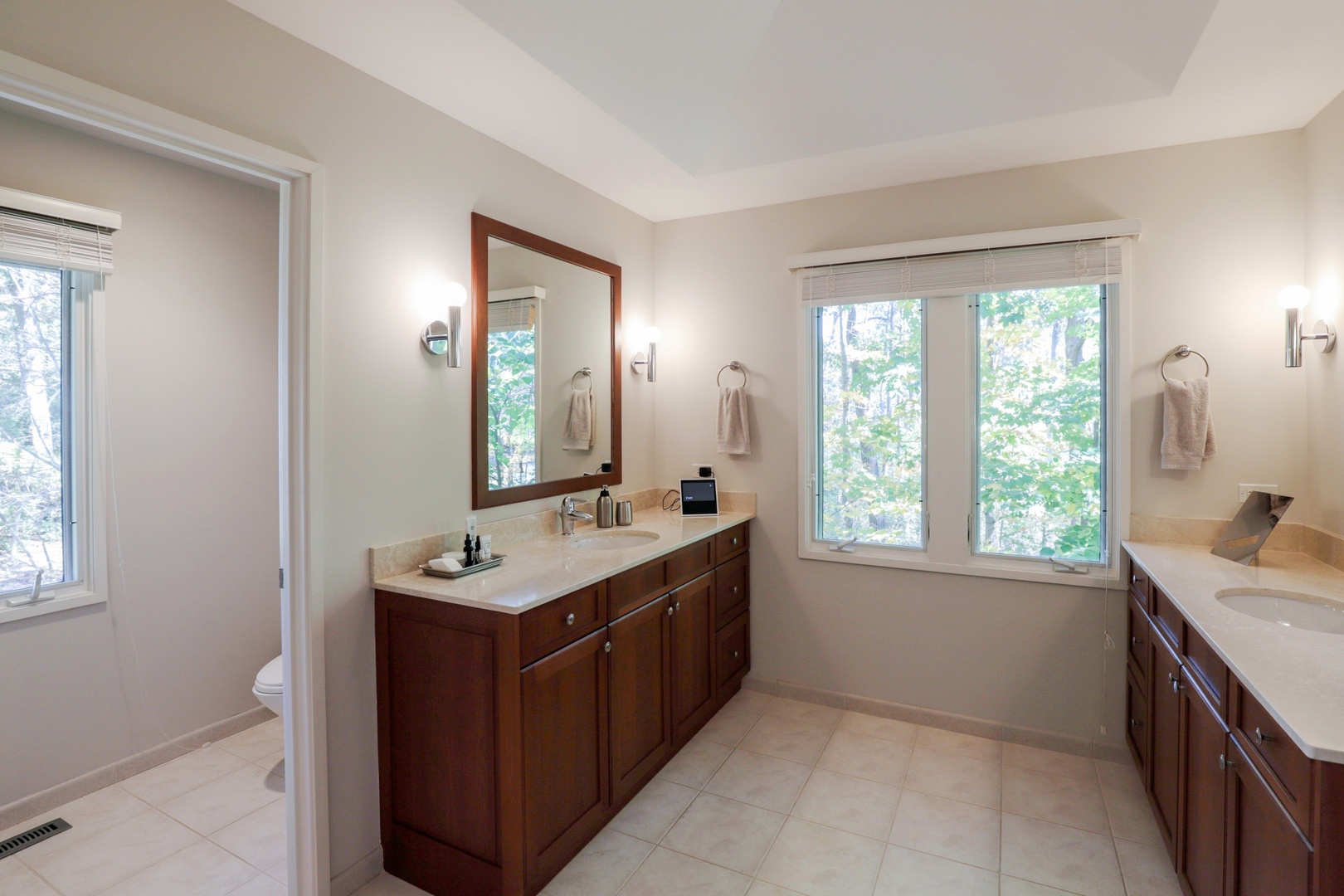 506 Forest Cove Road Lake Bluff, IL 60044 - Photo 27 of 53 a bathroom with a granite countertop sink a large mirror and a window