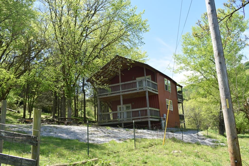 14436 Indian Springs Road Buffalo Valley, TN 38548 - Photo 11 of 24 a house with trees in front of it