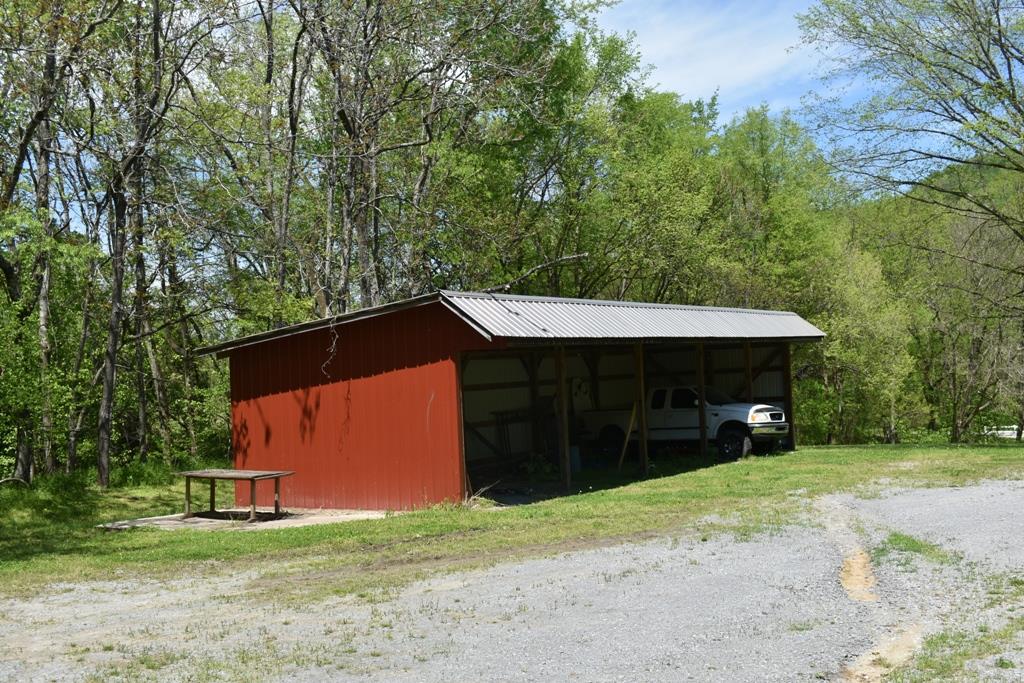 14436 Indian Springs Road Buffalo Valley, TN 38548 - Photo 16 of 24 a front view of a house with a yard and garage