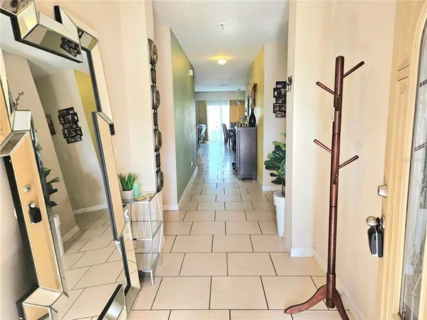 a view of a hallway with wooden floor and glass door