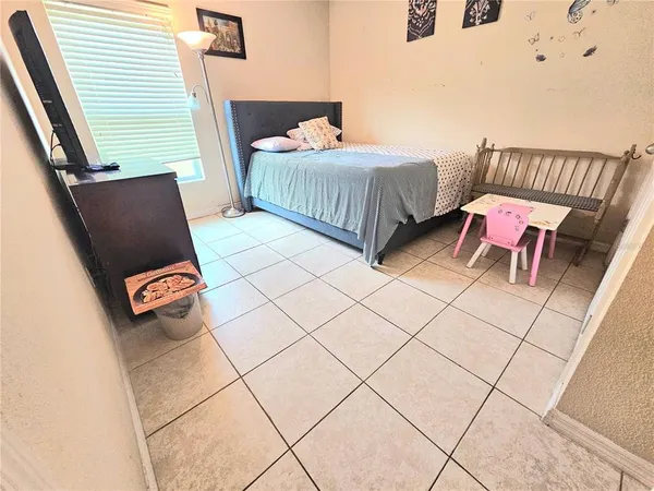 a bedroom with a bed and a mirror