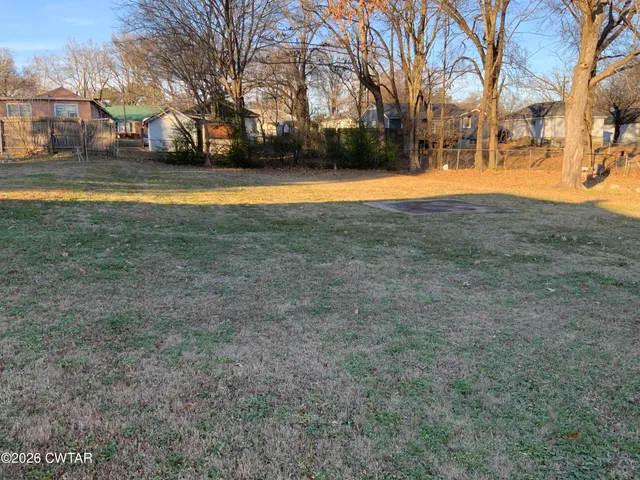 a view of outdoor space with trees all around
