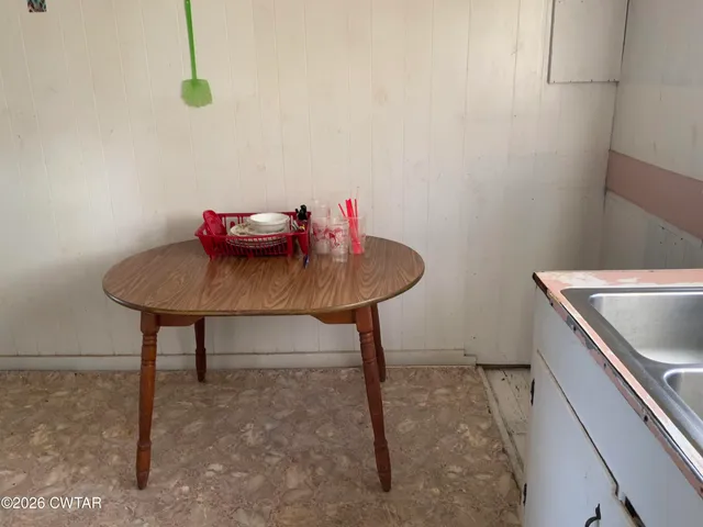 a view of a room with table and chairs