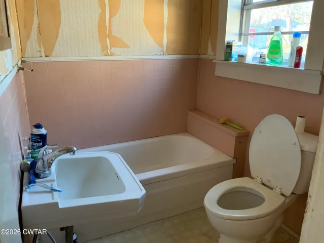 a bathroom with a toilet and a sink
