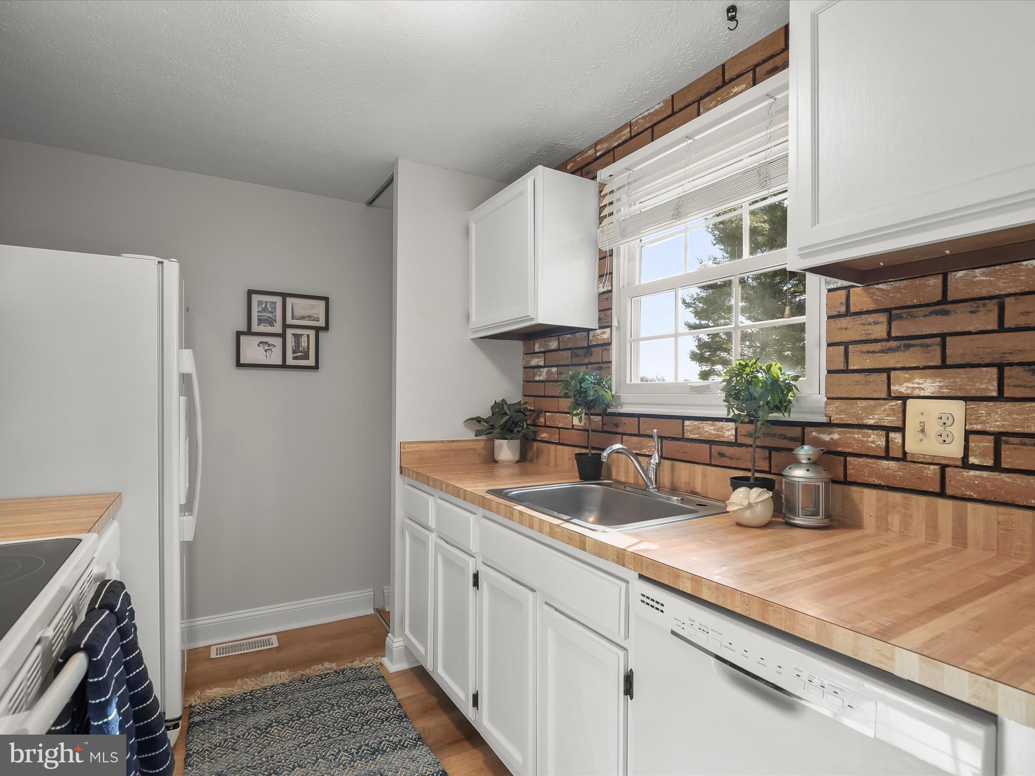 7971 Quail Court Glen Burnie, MD 21061 - Photo 16 of 52 a kitchen with stainless steel appliances a sink a refrigerator and a counter space