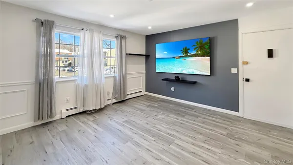 a view of room with window and wooden floor