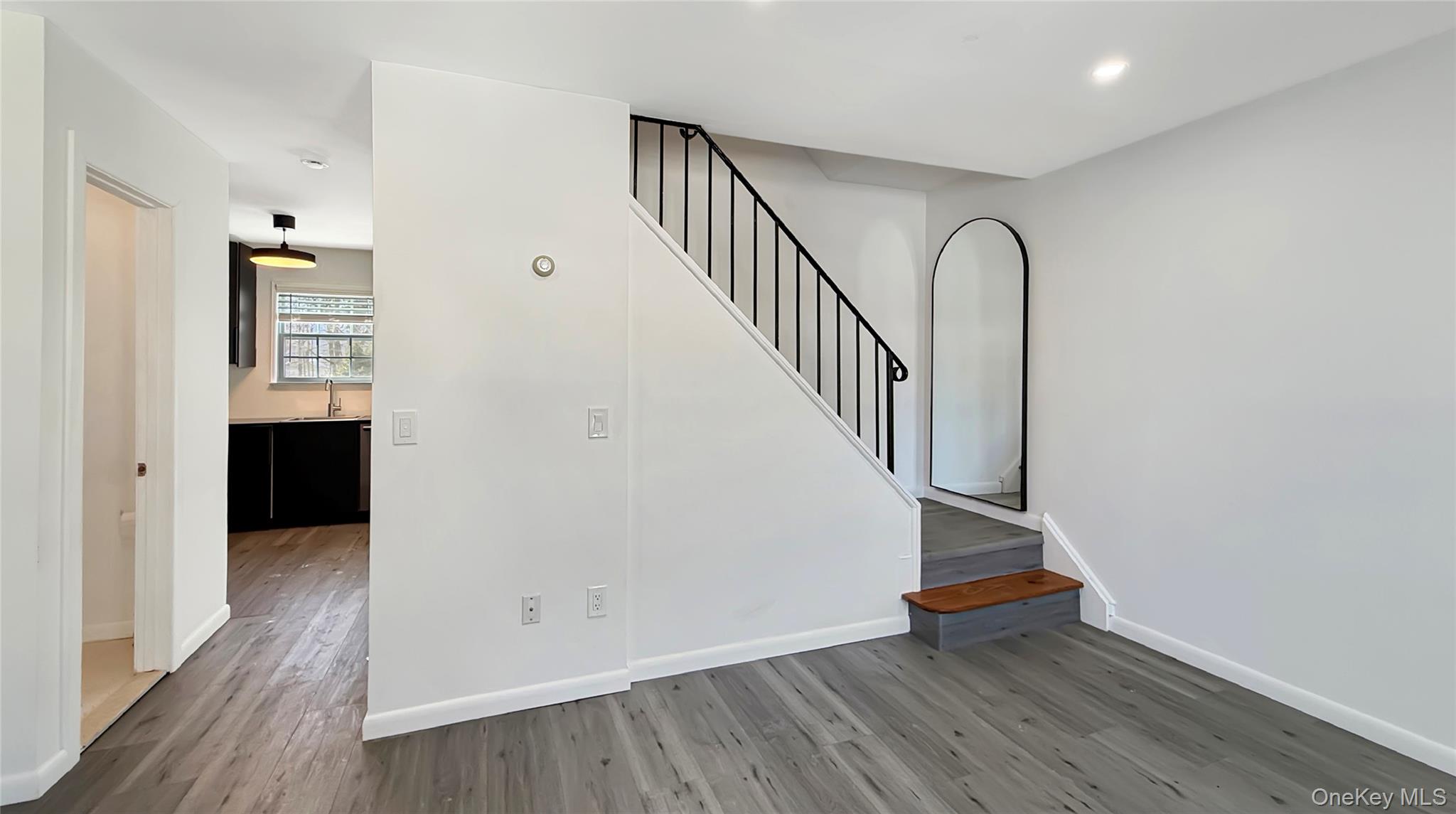 4 Forge Gate Drive, Unit F6B Cold Spring, NY 10516 - Photo 4 of 9 a view of an entryway with wooden floor and staircase