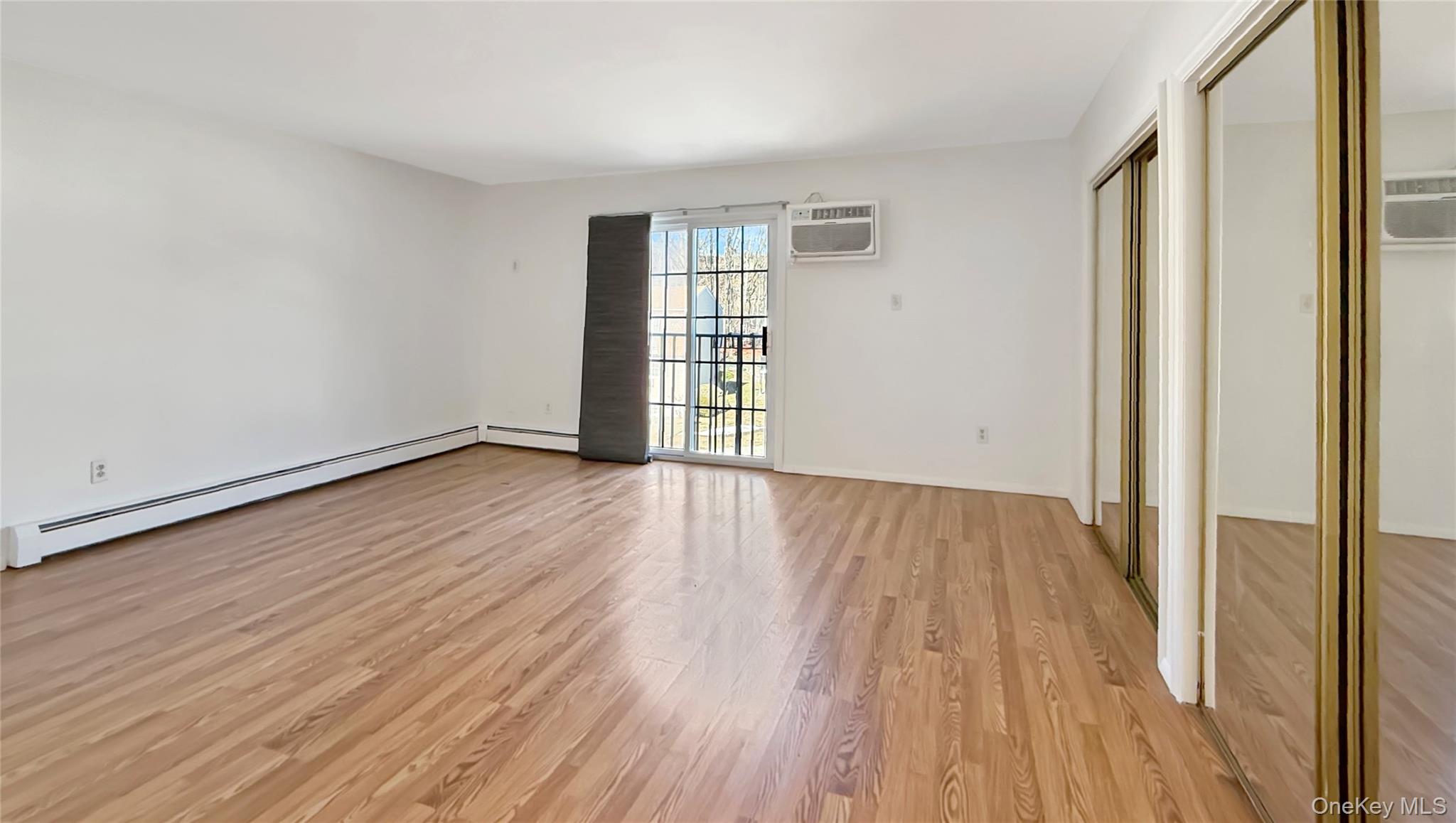 4 Forge Gate Drive, Unit F6B Cold Spring, NY 10516 - Photo 5 of 9 a view of an empty room with wooden floor and a window