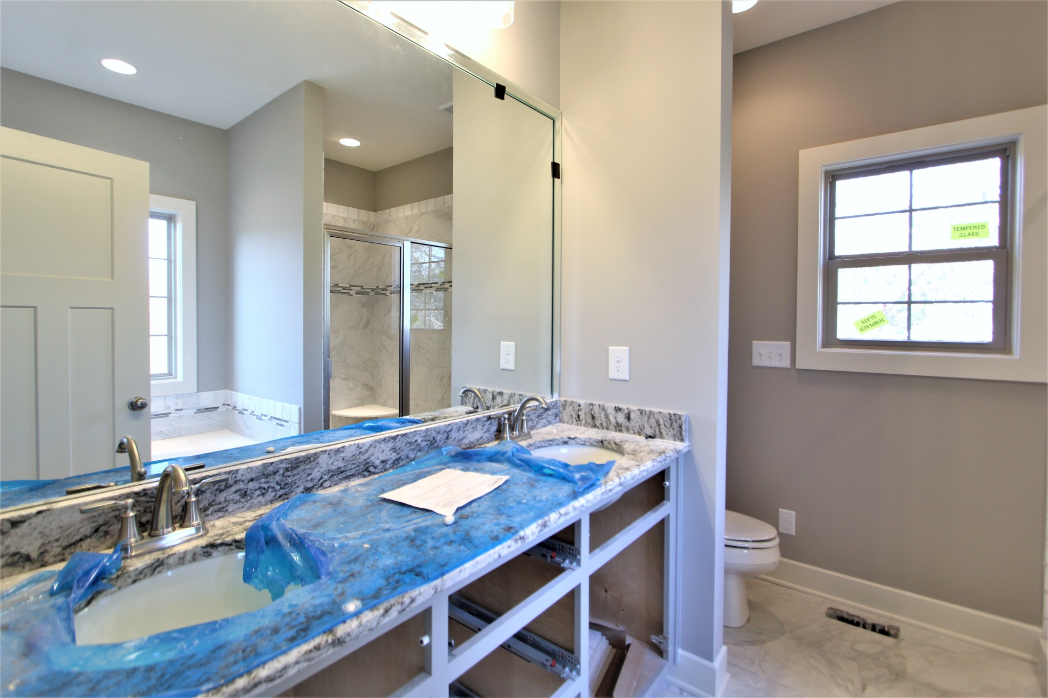 262 Ridgewater Way, Unit 83 Mount Juliet, TN 37122 - Photo 13 of 21 a bathroom with a granite countertop sink a toilet a mirror and a window