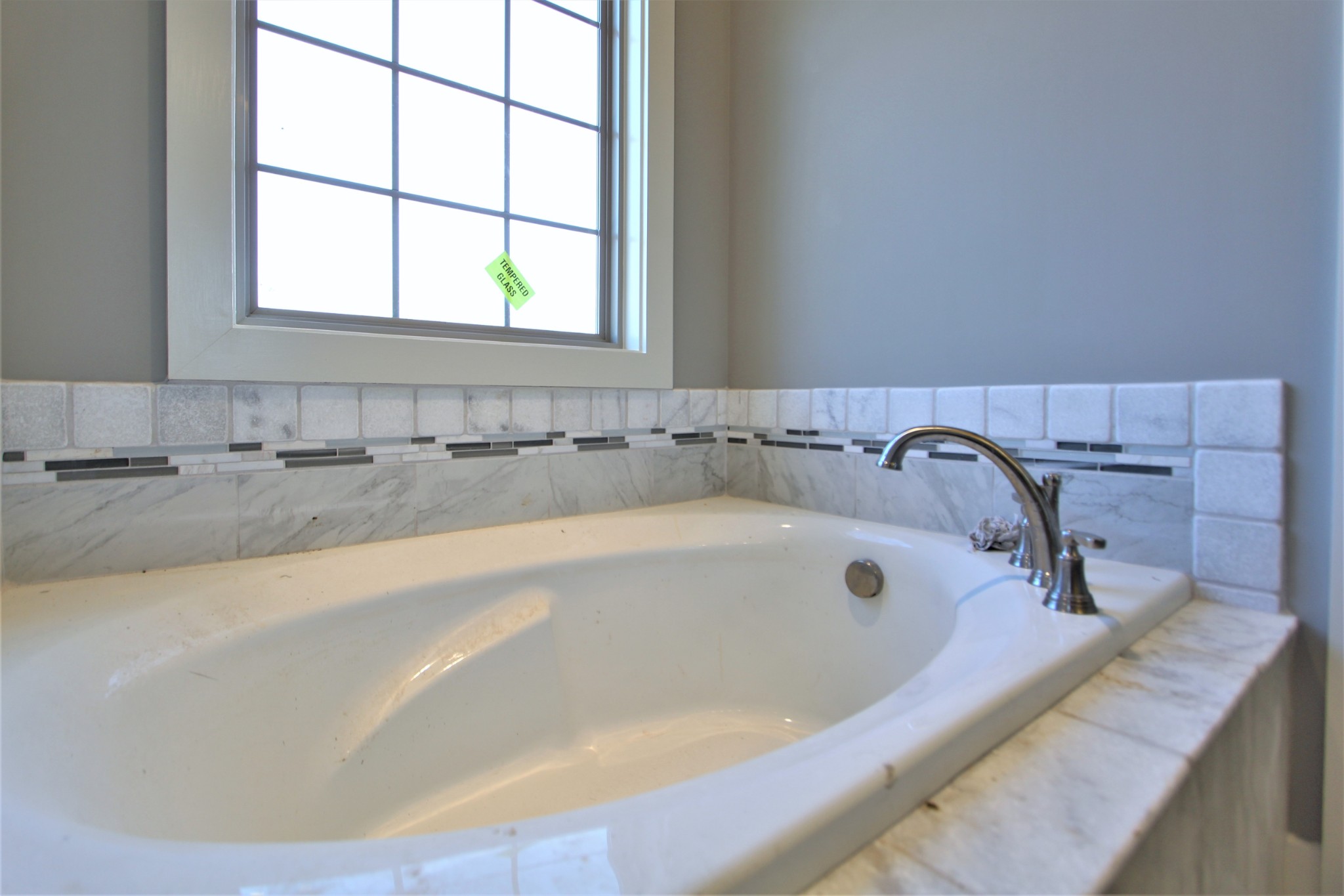 262 Ridgewater Way, Unit 83 Mount Juliet, TN 37122 - Photo 16 of 21 a bath tub sitting in a bathroom next to a window