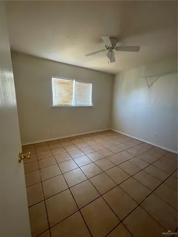 a view of an empty room and a window