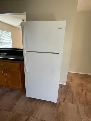a white refrigerator freezer sitting in a kitchen