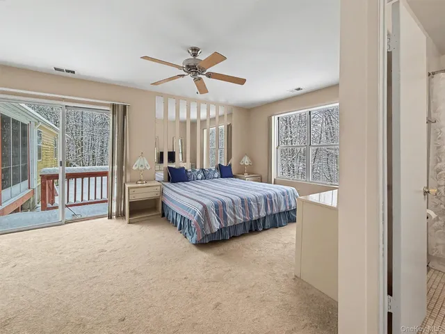 a bedroom with a balcony a bed and a window