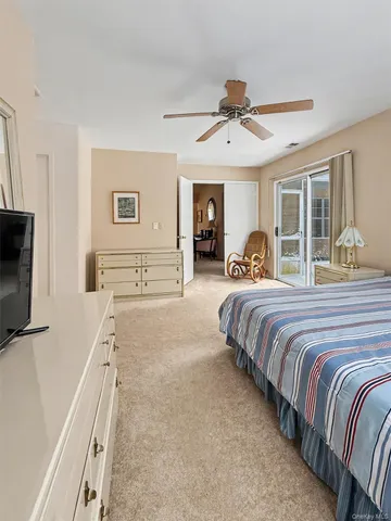 a bedroom with bed and a chandelier