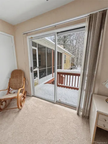 a view of a room with a window and chair