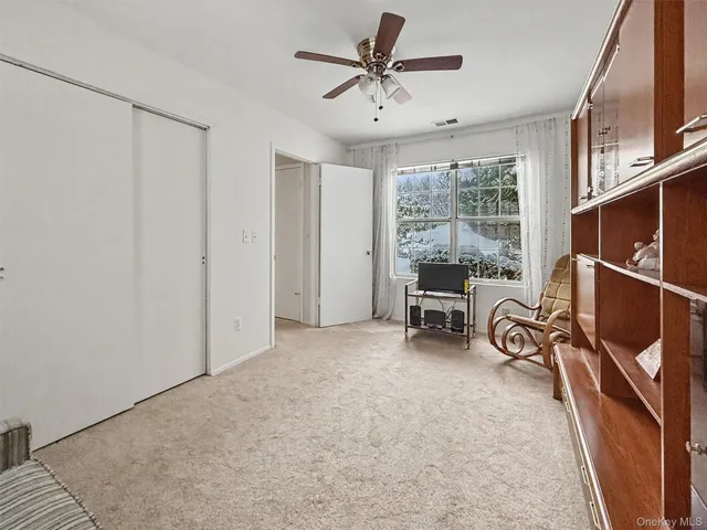 a view of a livingroom with furniture and a window