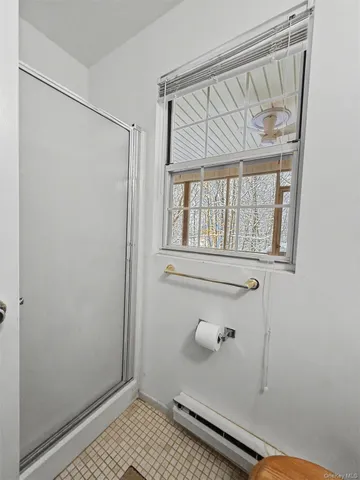 a bathroom with a glass door shower