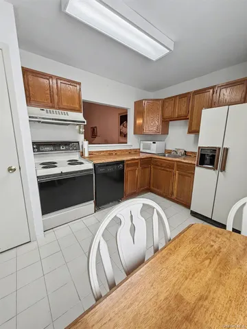 a kitchen with stainless steel appliances granite countertop a sink and a stove top oven