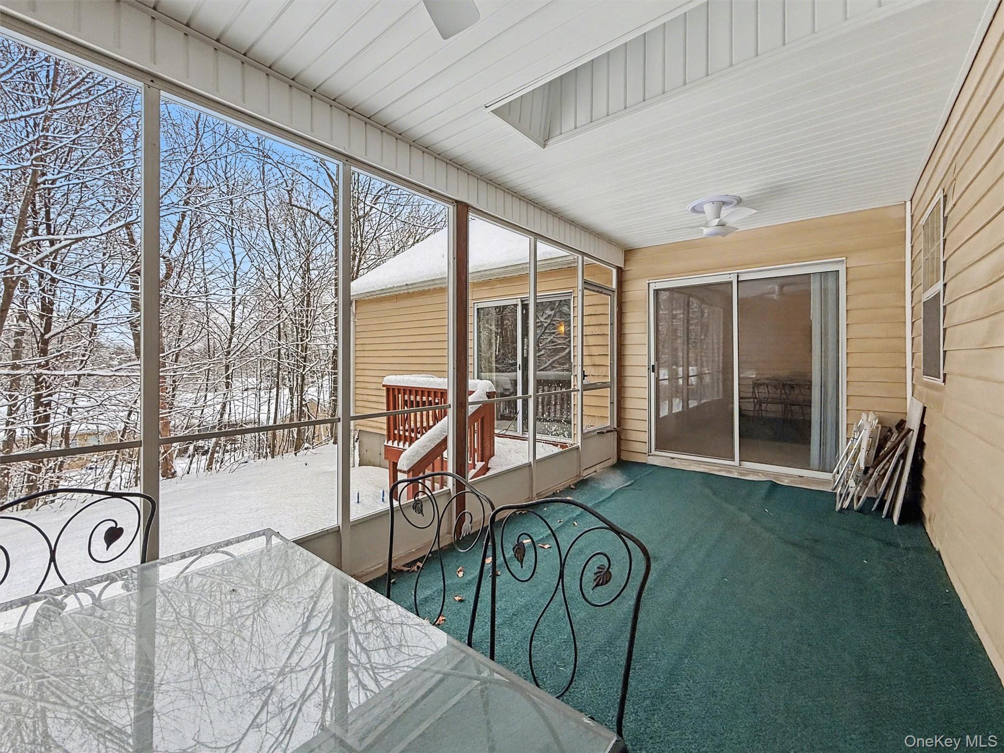 51 Hidden Ridge Drive Monticello, NY 12701 - Photo 10 of 31 Light-filled screened-in porch featuring skylights and ceiling fans, with plenty of room to relax and unwind.