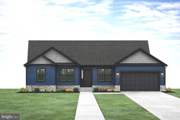 a front view of a house with a garden and yard