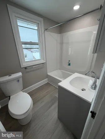 a white toilet sitting next to a bathroom sink