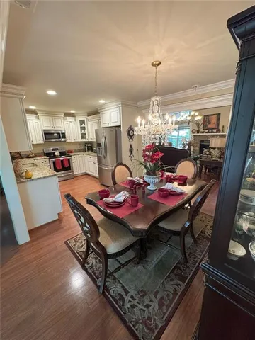 a view of a dining room with furniture and chandelier