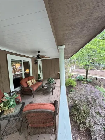 a living room with furniture and a floor to ceiling window