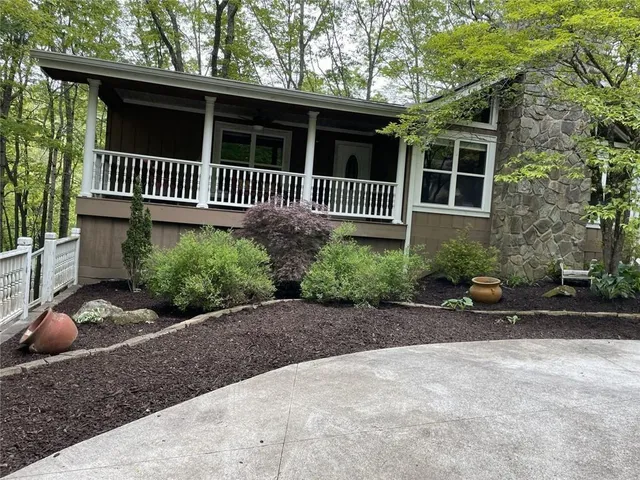 a view of a house with a bench in a patio
