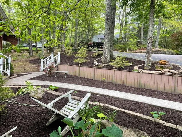 a view of a backyard with wooden fence