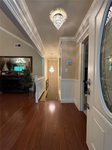 a view of a hallway view with wooden floor and staircase