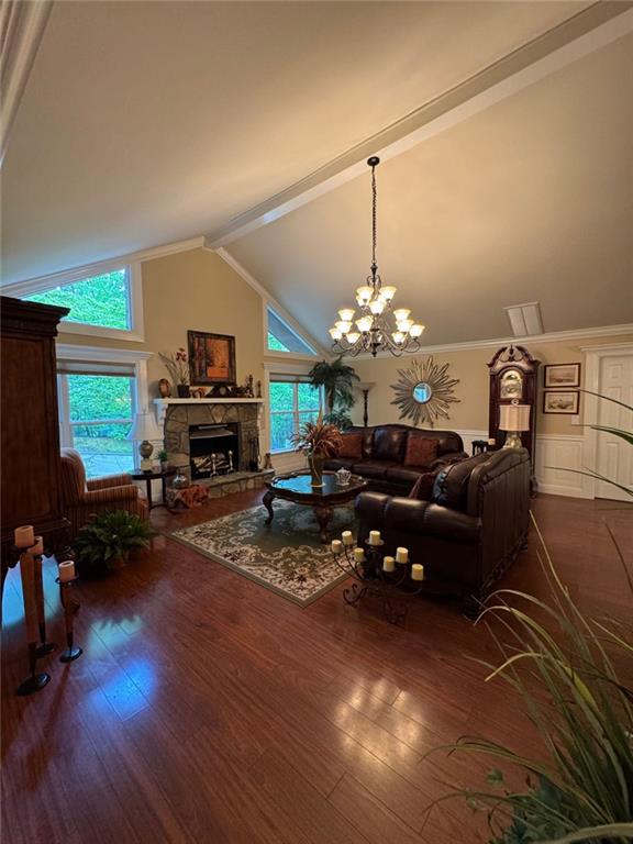 334 Eagle Circle Dillard, GA 30537 - Photo 9 of 29 a living room with furniture a fireplace and a chandelier