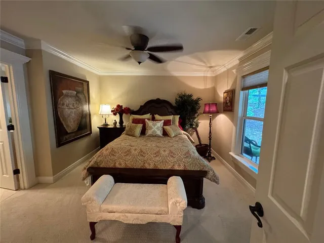 a bedroom with a bed and large mirror with furniture
