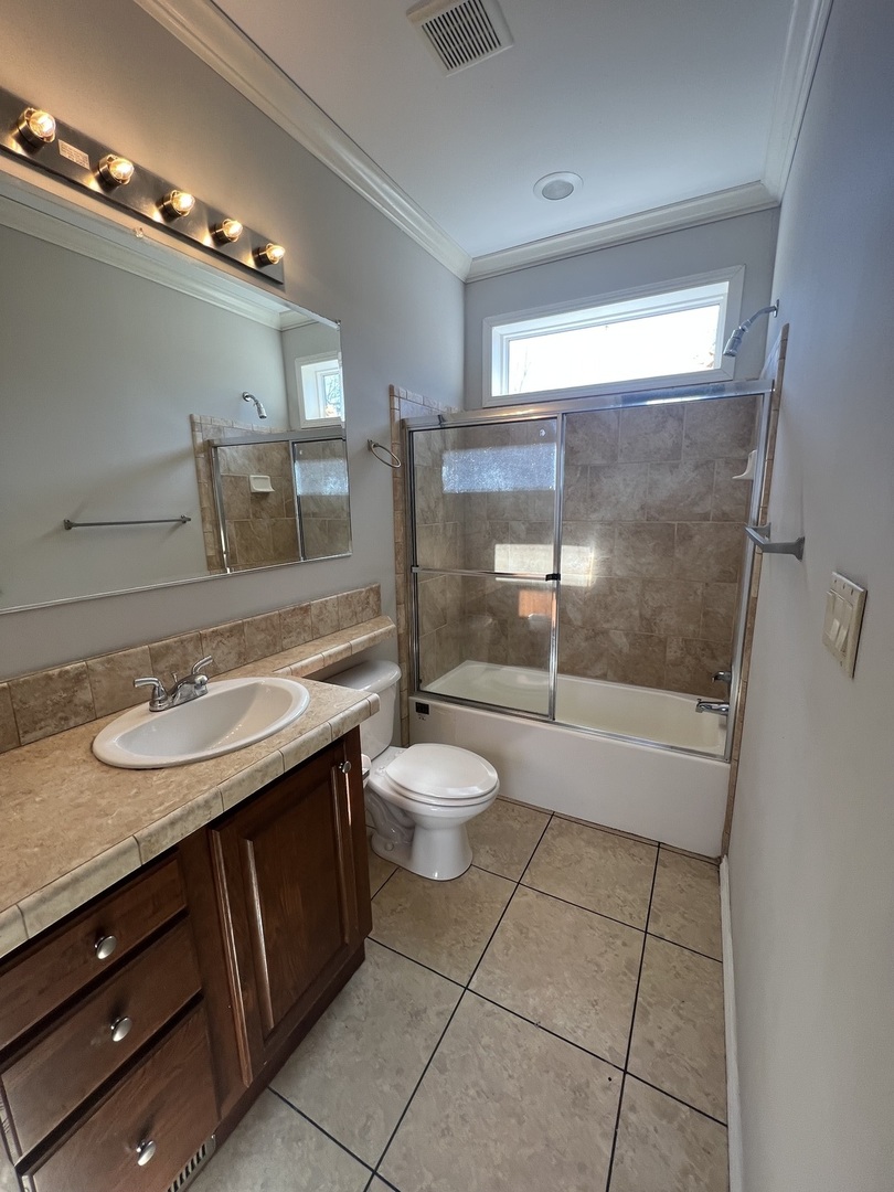 230 Northshore Road Elgin, IL 60123 - Photo 15 of 16 a bathroom with a granite countertop sink toilet a mirror and shower