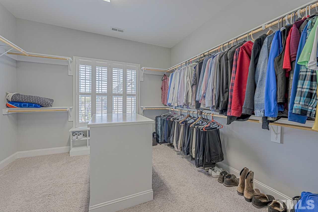 7605 Stonehenge Farm Lane Raleigh, NC 27613 - Photo 22 of 30 Large walk-in closet full of built-ins and center console.