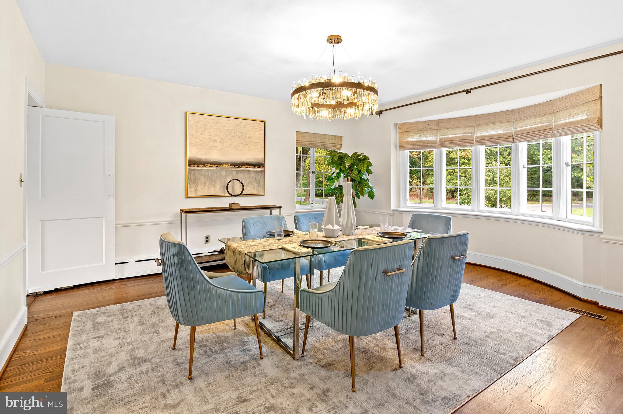 7704 Crossland Road Pikesville, MD 21208 - Photo 13 of 68 a view of a dining room with furniture a chandelier and wooden floor