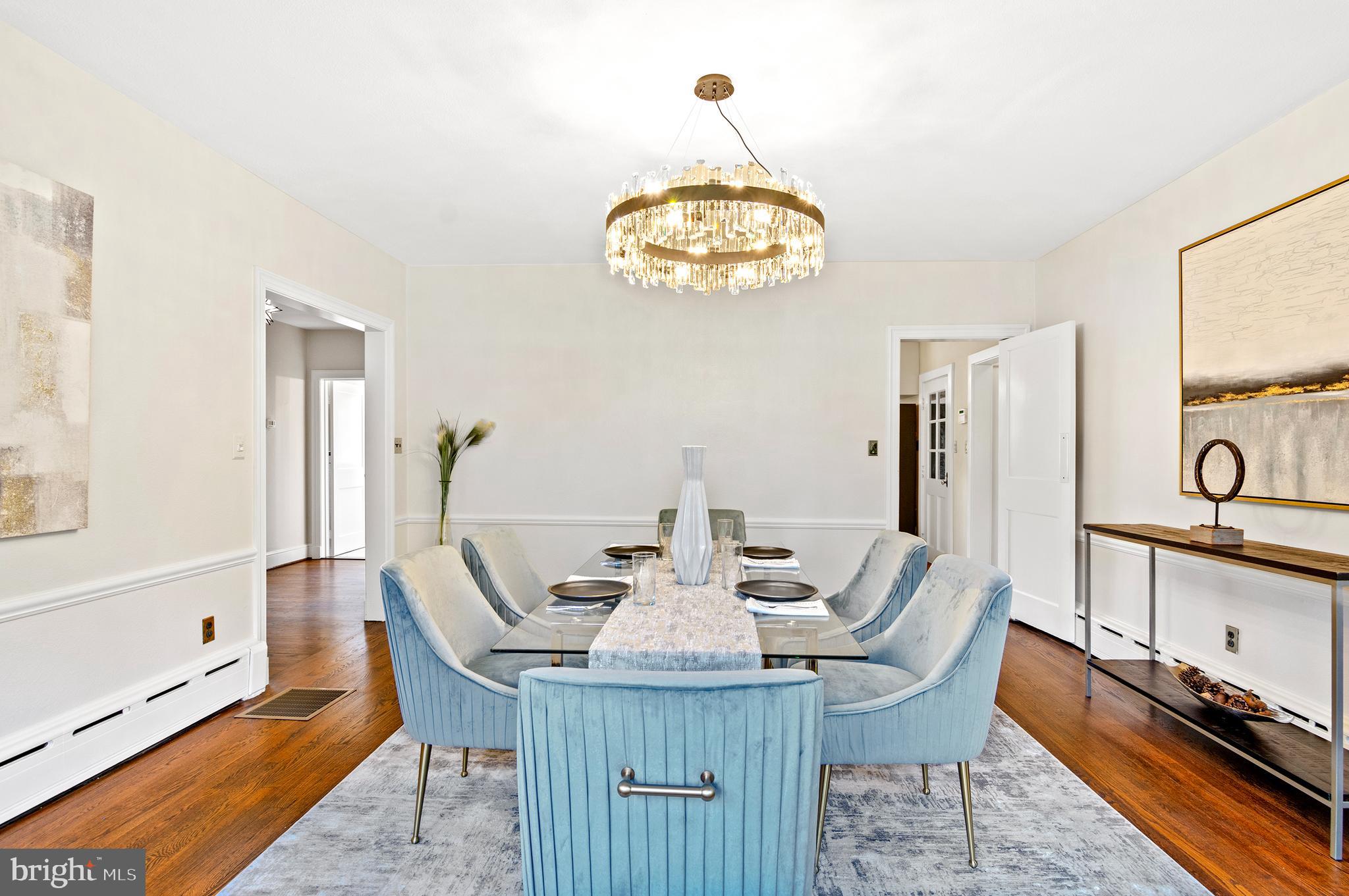7704 Crossland Road Pikesville, MD 21208 - Photo 14 of 68 a view of a dining room with furniture a chandelier and wooden floor