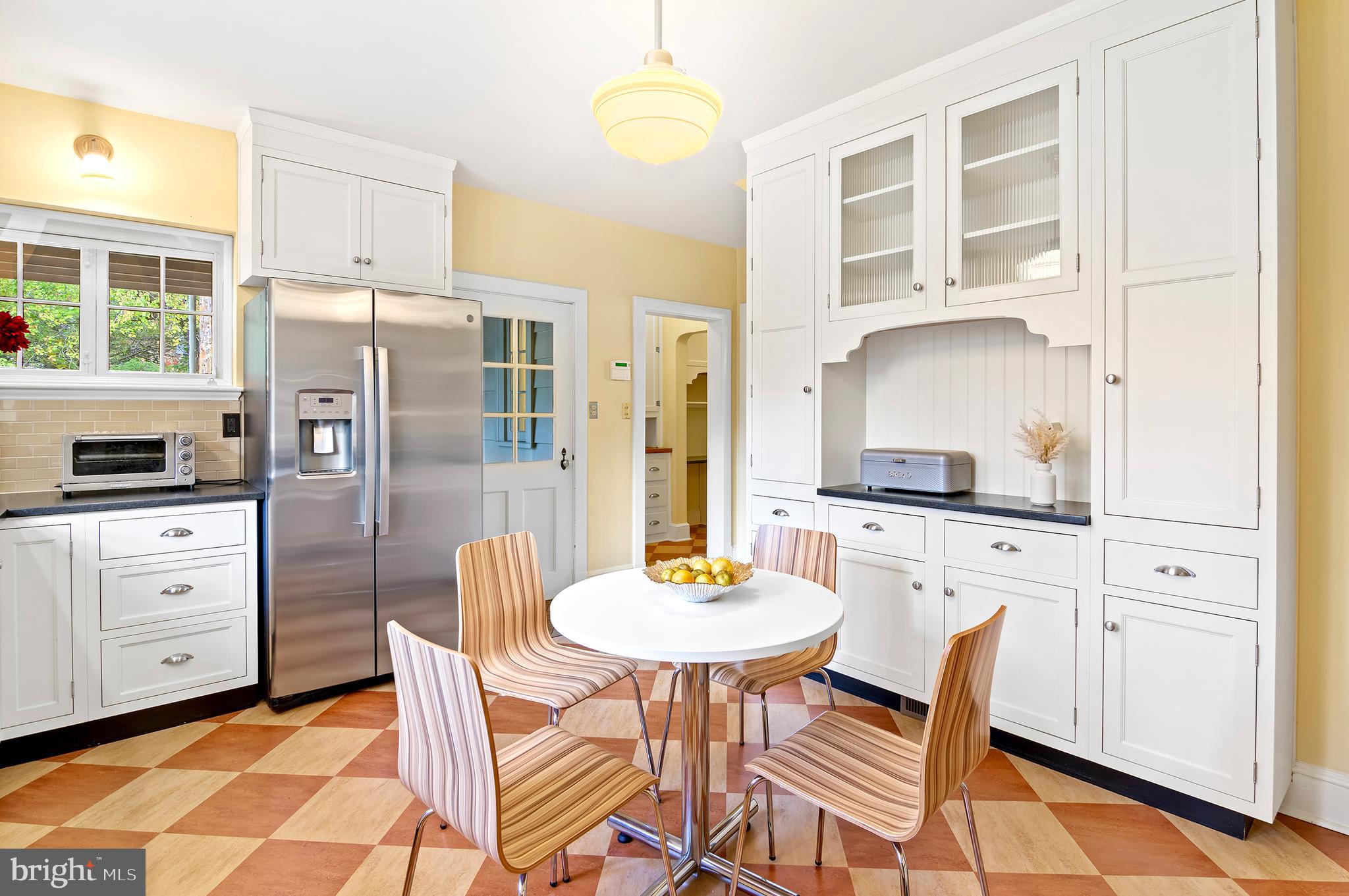 7704 Crossland Road Pikesville, MD 21208 - Photo 20 of 68 a kitchen with stainless steel appliances a dining table chairs and chandelier