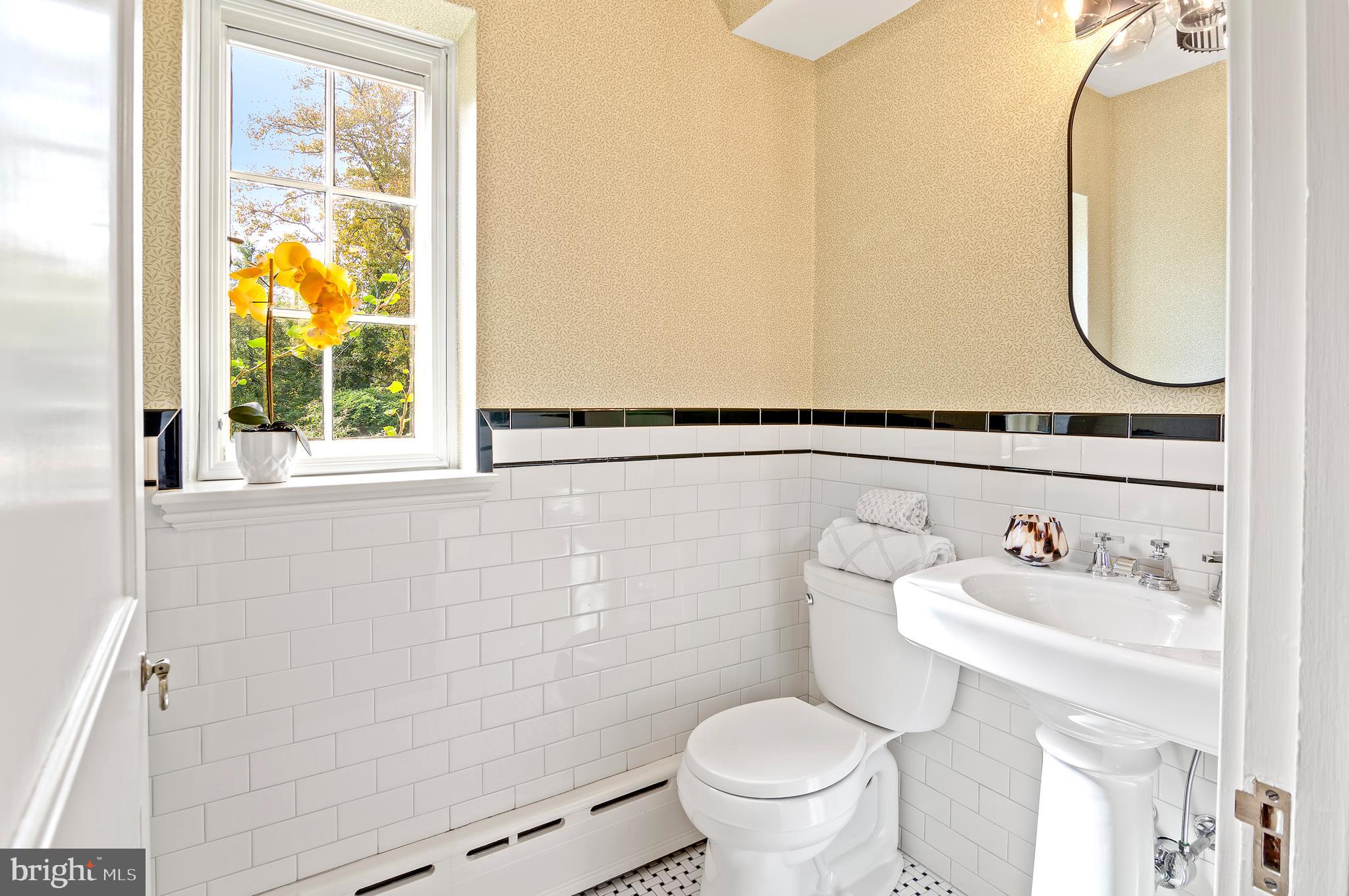 7704 Crossland Road Pikesville, MD 21208 - Photo 23 of 68 a bathroom with a sink mirror and a toilet