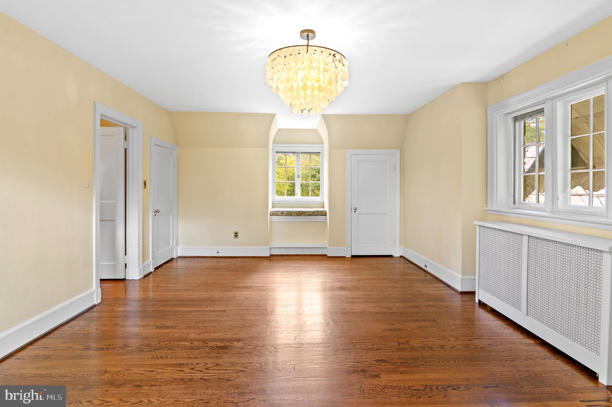 7704 Crossland Road Pikesville, MD 21208 - Photo 26 of 68 a view of empty room with wooden floor and fan