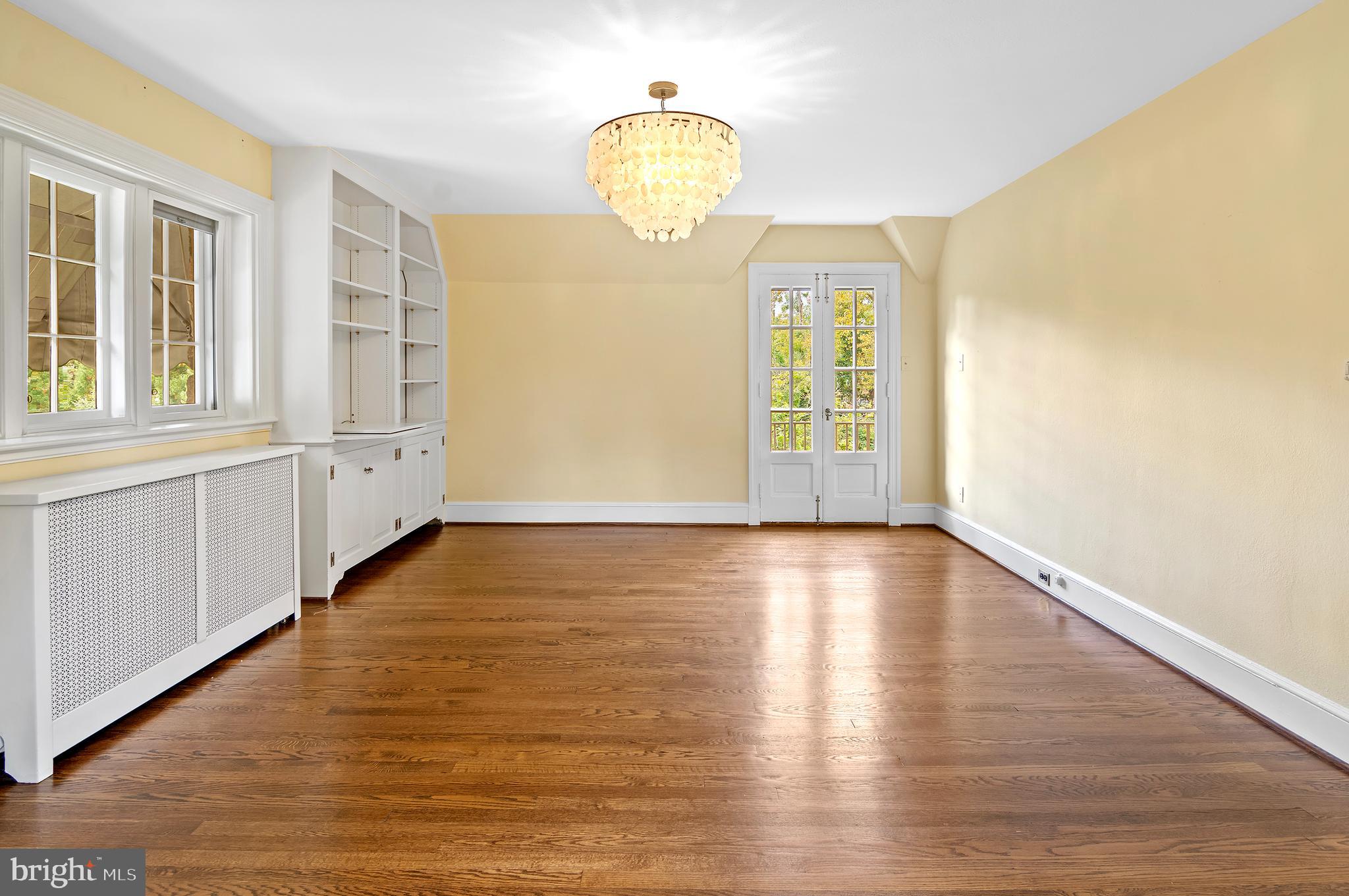 7704 Crossland Road Pikesville, MD 21208 - Photo 27 of 68 a view of empty room with wooden floor and fan