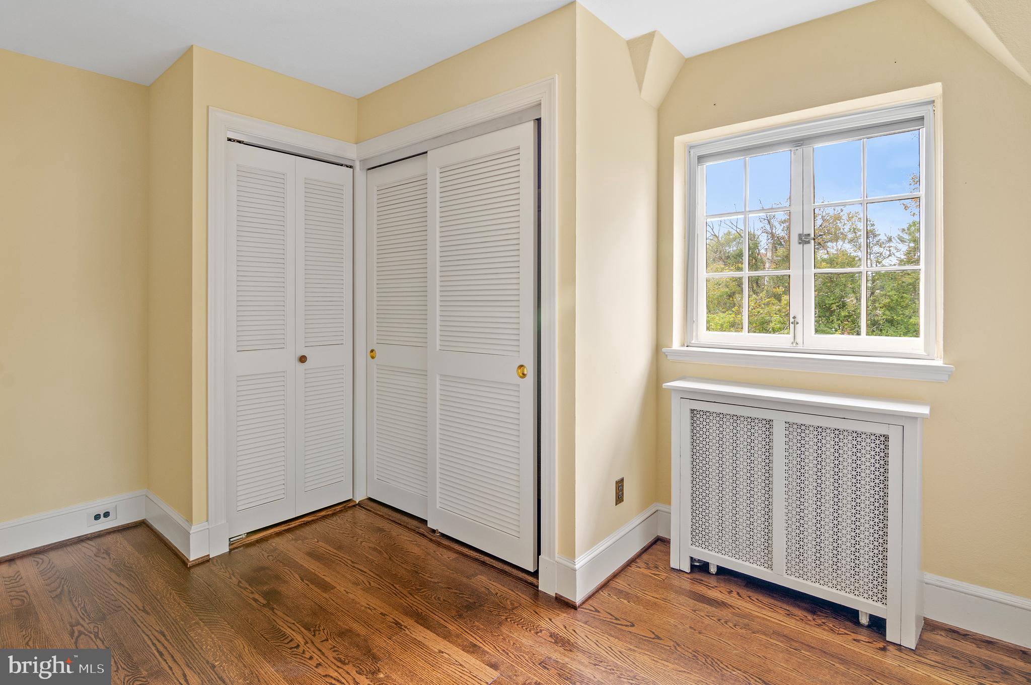 7704 Crossland Road Pikesville, MD 21208 - Photo 32 of 68 a view of an empty room with wooden floor and a window