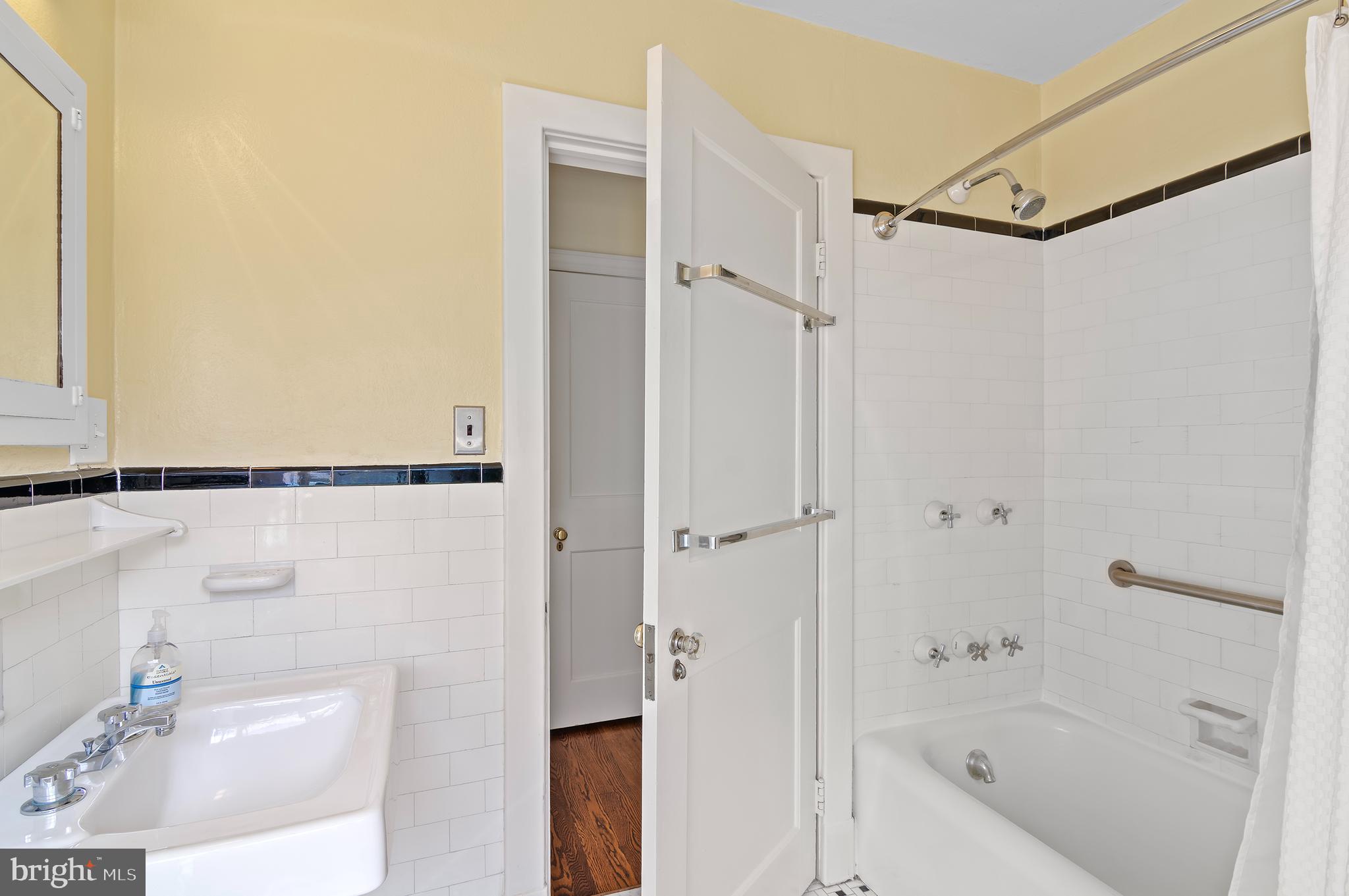 7704 Crossland Road Pikesville, MD 21208 - Photo 34 of 68 a bathroom with a bathtub and a sink