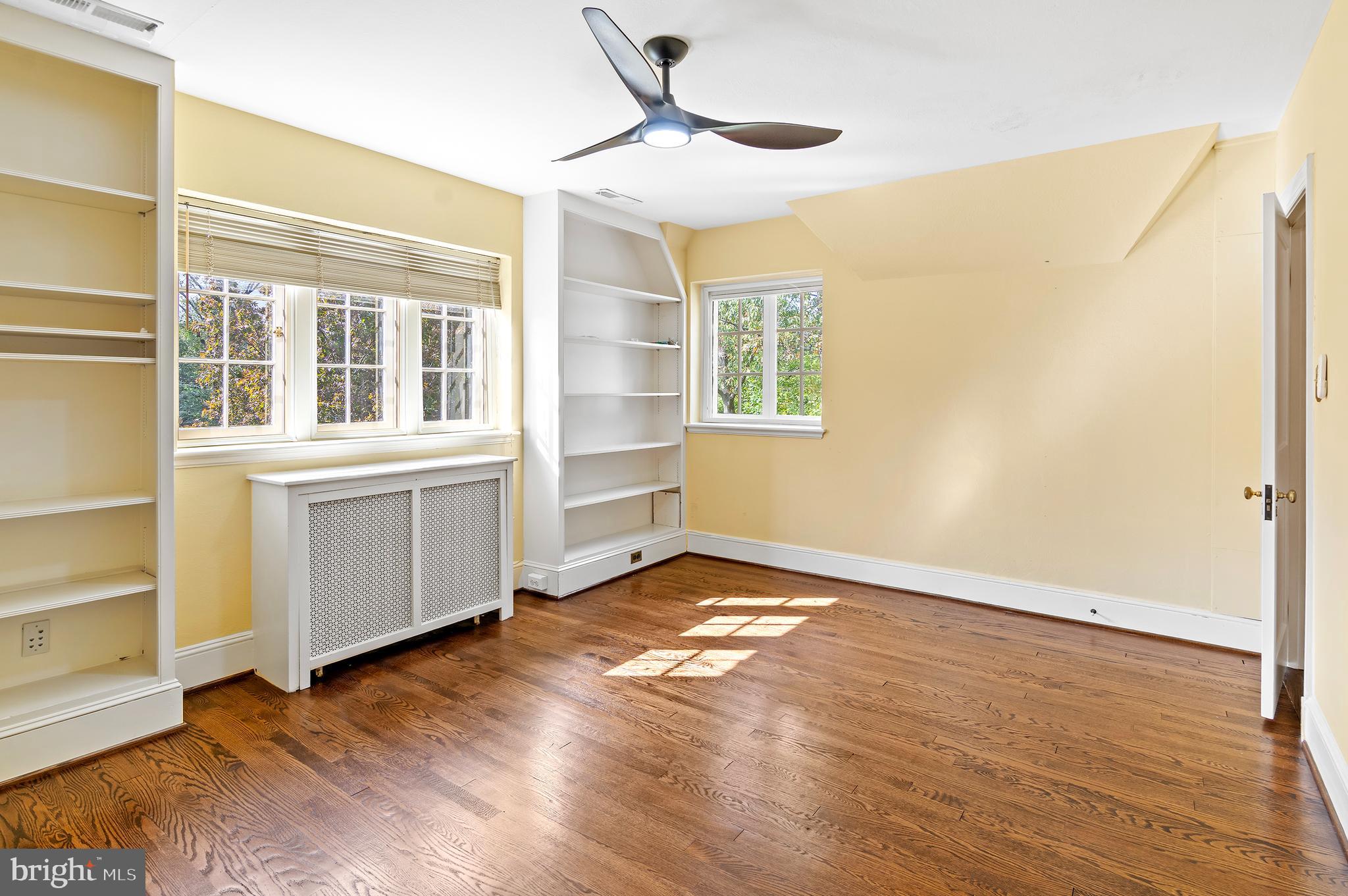 7704 Crossland Road Pikesville, MD 21208 - Photo 36 of 68 a view of an empty room with a window and wooden floor