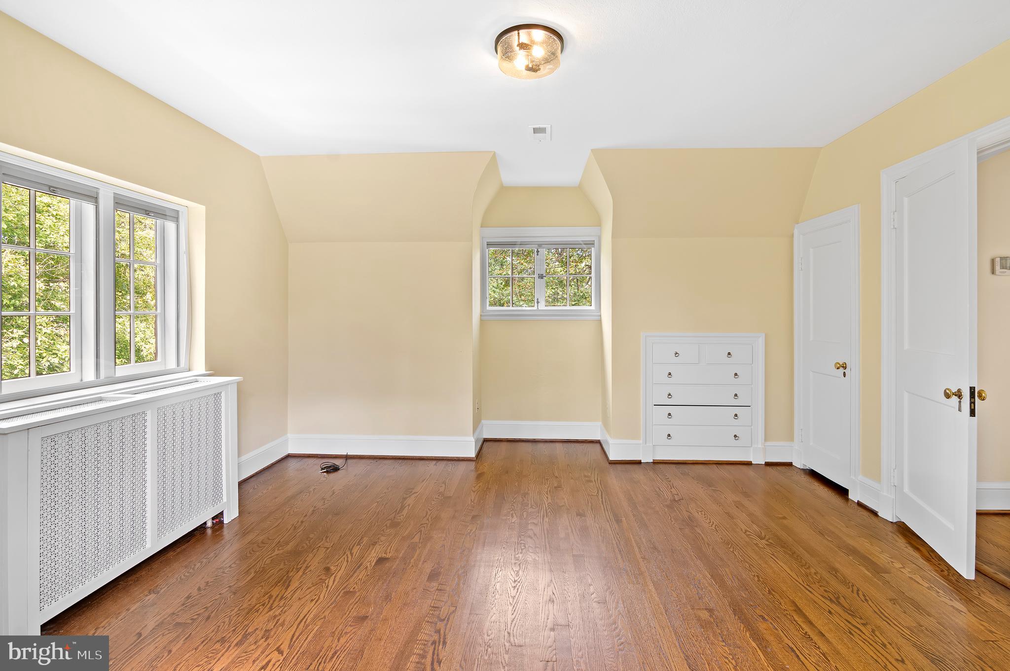 7704 Crossland Road Pikesville, MD 21208 - Photo 37 of 68 an empty room with wooden floor and windows